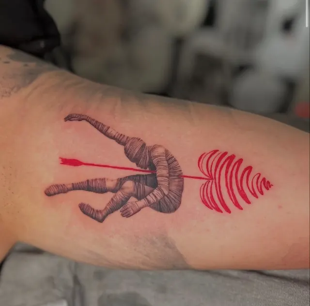 Red ink figure pierced by an arrow